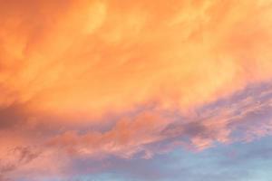 Beautiful summer sunset with orange sky and clouds photo