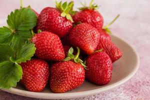 Heap of fresh strawberries in ceramic bowl photo