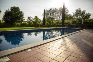 Outdoor swimming pool on the open air with beautiful view to the garden. photo