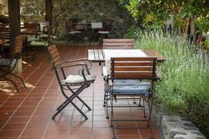 Close up view of outdoor tables of restaurant waiting for customers. photo