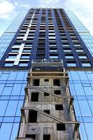 A fragment of the facade of a house under construction, a modern building is being built, the view is directed upwards. photo