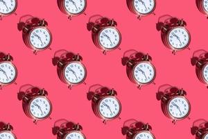 Alarm clock on a colored background hard shadows. Close up. Seamless patterns photo