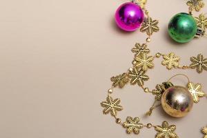 Mock up close-up New Year's top view, spruce multicolored toys with golden snowflakes. Postcard layout. photo