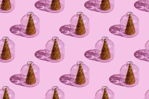 Christmas tree under glass on a pink background. Christmas concepts with copy space. New year and christmas concept in quarantine. Quarantine sample photo