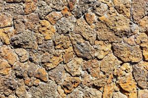 The rough masonry of the wall is made of old orange shell rock.