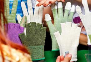 Fabric protective gloves in various colors, shapes and textures for women. photo