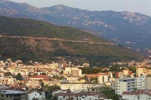 View of the modern city of Budva Riviera on the background of a sea bay and a mountain chain photo