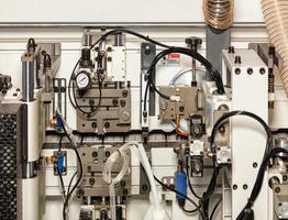 The mechanism and internal structure of a modern woodworking machine close-up. photo