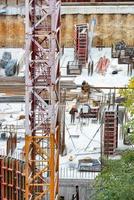 Components of a tower crane on the background of a construction site for the foundation of a modern building with formwork and reinforcement. photo