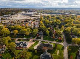 Aerial view of residential neighborhood in Northfield, IL. Lots of trees starting to turn autumn colors. Large residential homes, some with solar panels. Meandering streets photo