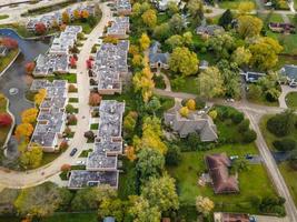 Aerial view of residential neighborhood in Northfield, IL. Lots of trees starting to turn autumn colors. Large residential apartment complexes. Meandering streets with large trees. photo