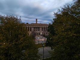 Aerial view of Kenosha County Courthouse. Park and trees across street. Checkered blue sky.  Bricks lining sidewalk. photo