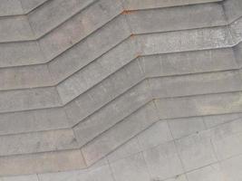 Chevron pattern steps in Anderson Park, Kenosha, Wisconsin. Shades of gray weathered concrete. Diagonal lines and straight lines present. photo