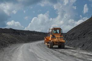 Crawler bulldozer making way through the hill. photo