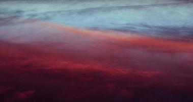 Intense colors of blood red pink blue cloud formations photo