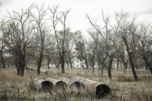 View of an abandoned park with old rusty iron pipes. photo