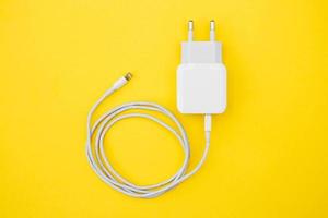 Mobile charger and USB Cable on yellow background photo