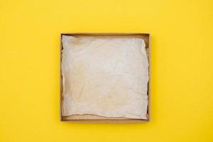 Open carton box on yellow background photo