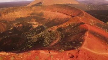 Drone video of a person in the top of a volcano in Lanzarote, Canary Islands, Spain.