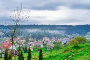 Beautiful mountain village in the Carpathians after rain on a warm summer day photo