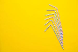 Drinking plastic straws on a yellow background photo