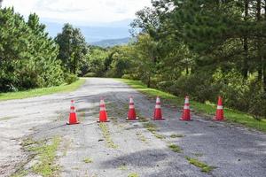 Road cone - orange traffic cones standing in a row on asphalt on the road mountain photo