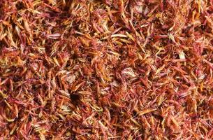 Dried safflower for herbal tea on background, dry safflower petals, Saffron substitute photo