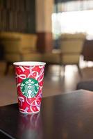 BANGKOK, THAILAND - Nov 24, 2021- Starbucks hot beverage coffee with Christmas theme on the table. photo