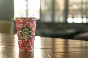 BANGKOK, THAILAND - Nov 24, 2021- Starbucks hot beverage coffee with Christmas theme on the table. photo