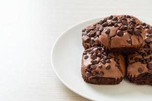 dark chocolate brownies topped by chocolate chips photo