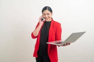 Asian business woman talking telephone with hand holding labptop