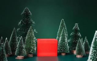 christmas tree group and red vivid product display block on green background. photo