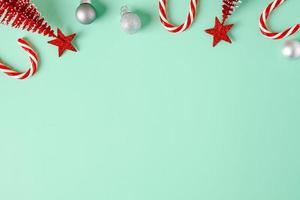 top view christmas ornament xmas tree,candy cane,bauble decor on pastel green background photo