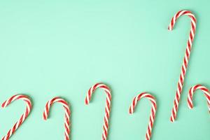 red candy cane group on pastel green background photo