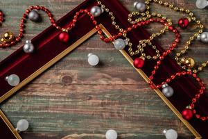 Christmas decoration ornament tiensel,ball and red frame n table wood background photo