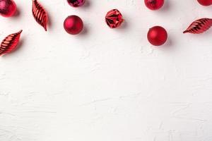Christmas red bauble ball decoration on white pastel table background
