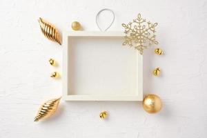 Christmas white picture frame and bauble,gift box,star decoration ornament on white concrete table photo