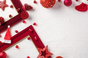 Christmas red picture frame and bauble decoration ornament on white concrete table background photo