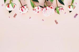 Greeting card with peonies and pink hearts. photo