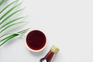 soy sauce in a container with leaf on white background photo