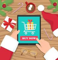 santa claus está comprando regalos en tableta digital en e-shop - ilustración de vector de diseño plano