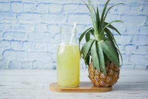 pineapple juice in a bottle on table photo