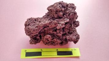 specimen Scoria igneous rock, brownish red color from the Rinjani volcano, Indonesia. Basaltic lava, oxidation of iron during eruptions. Rocks and minerals identification photo