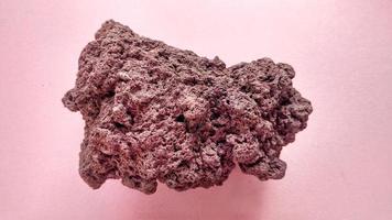 specimen Scoria igneous rock, brownish red color from the Rinjani volcano, Indonesia. Basaltic lava, oxidation of iron during eruptions. Rocks and minerals identification photo