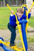 A wonderful Ukrainian boy performs exercises on simulators photo