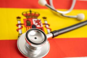 Black stethoscope on Spain flag background, Business and finance concept. photo