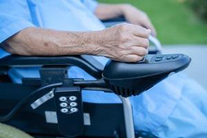 Asian senior or elderly old lady woman patient on electric wheelchair with remote control at nursing hospital ward, healthy strong medical concept photo