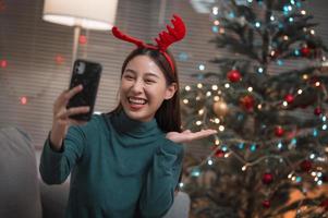 Asian woman video call via smartphone to celebrate Christmas photo