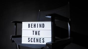 Director chair with behind the scene banner light box. photo