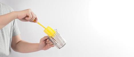 Clean and wash dish concept. Man hand washing drink glass on white background. photo